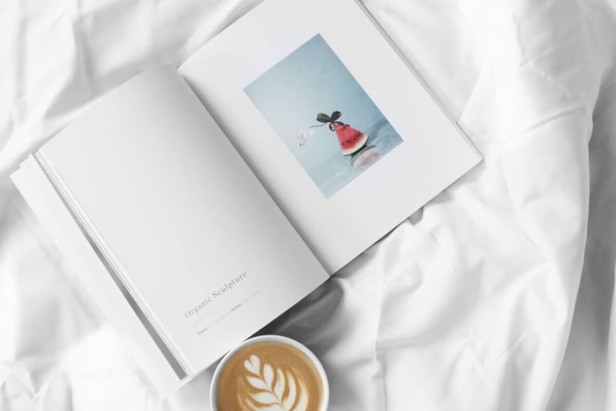 Open Book with Coffee on White Sheets
